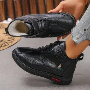 Women's black velvet house shoes with a hollow-out design and non-slip rubber sole.