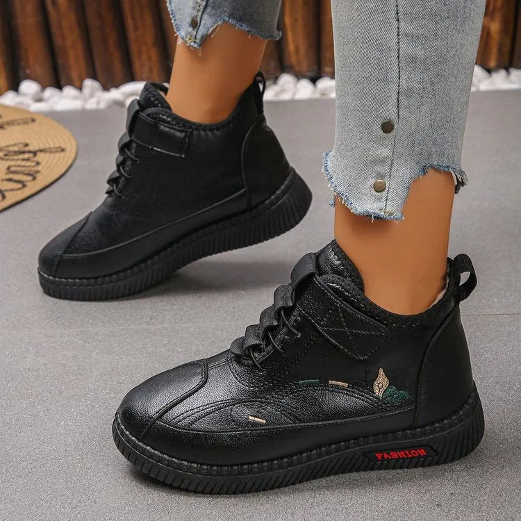 Women's black velvet house shoes with a hollow-out design and non-slip rubber sole.