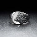 Silver geometric wolf ring for men on a grey background, showing angular retro design.