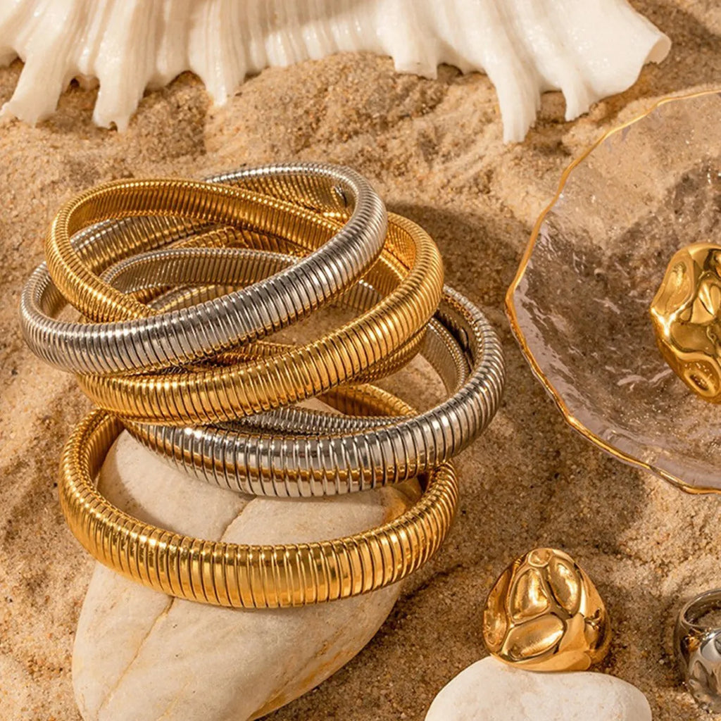 Women's titanium steel elastic bracelet with exaggerated vertical stripe pattern in gold finish