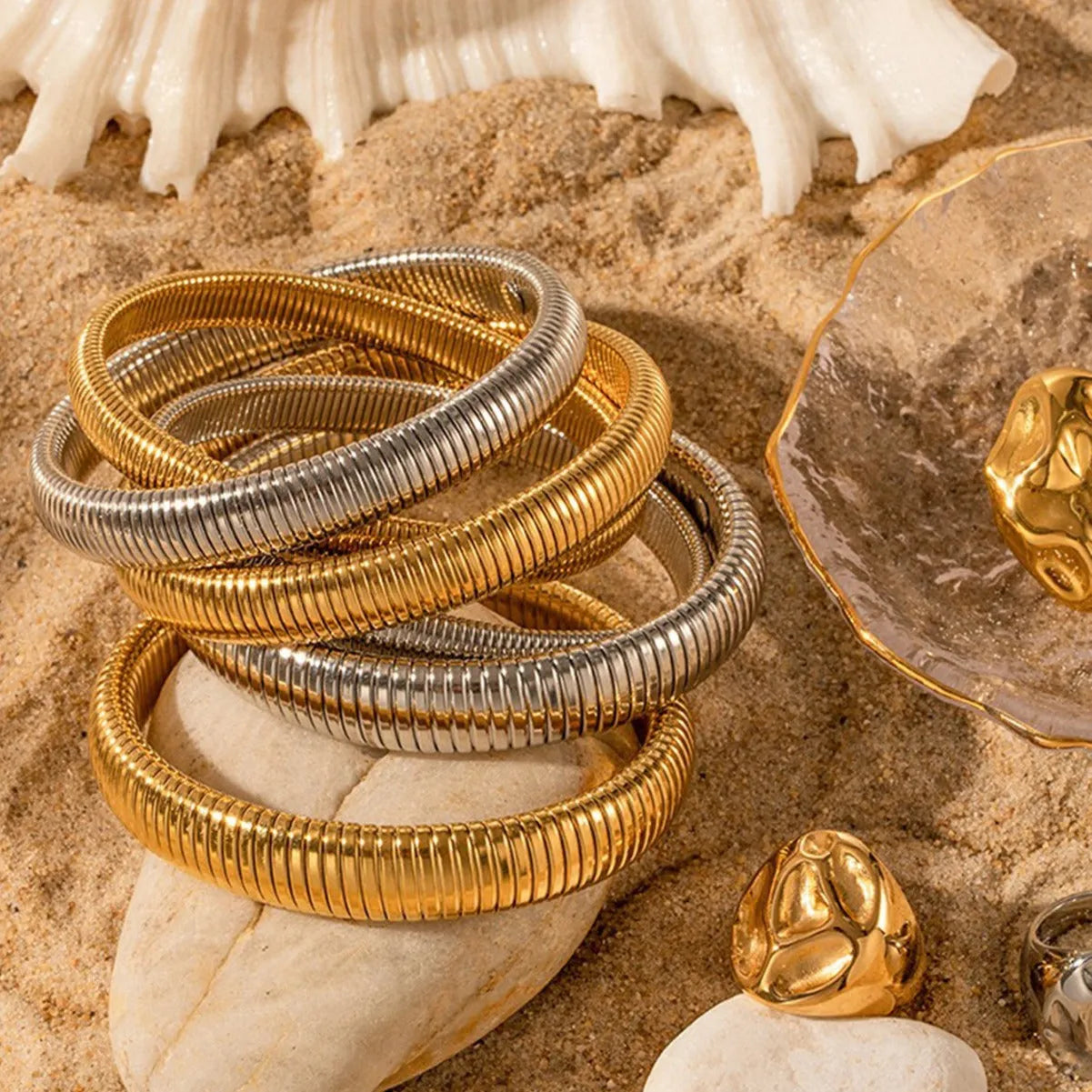 Women's titanium steel elastic bracelet with exaggerated vertical stripe pattern in gold finish