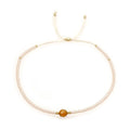 Handmade bohemian bracelet with colourful geometric glass beads on a female wrist.