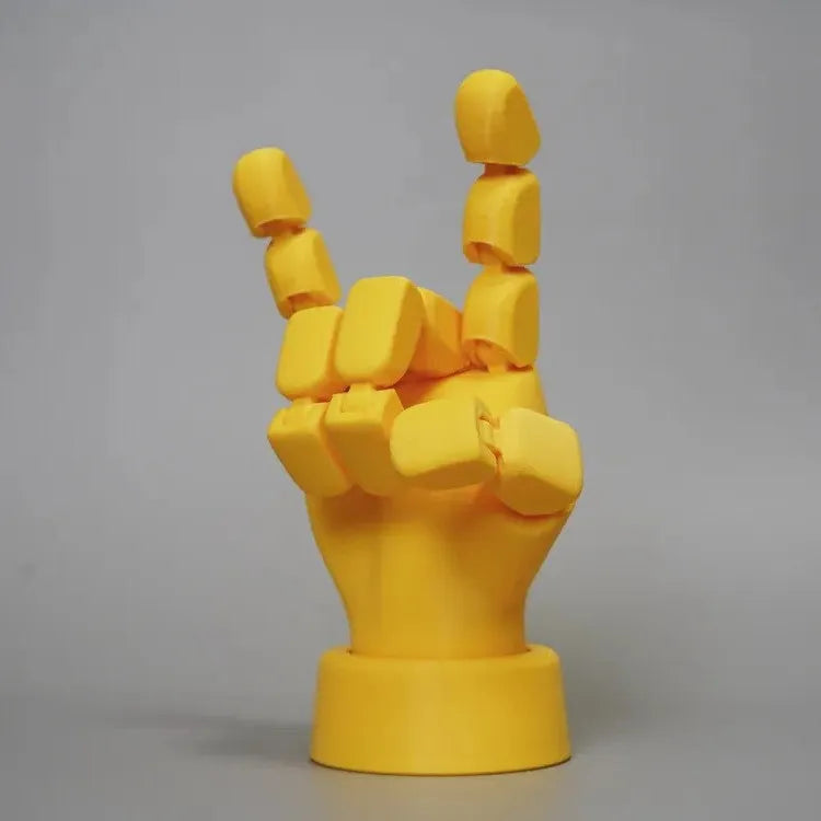 Yellow movable joint hand prop ornament made of PLA plastic on white background