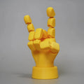 Yellow movable joint hand prop ornament made of PLA plastic on white background