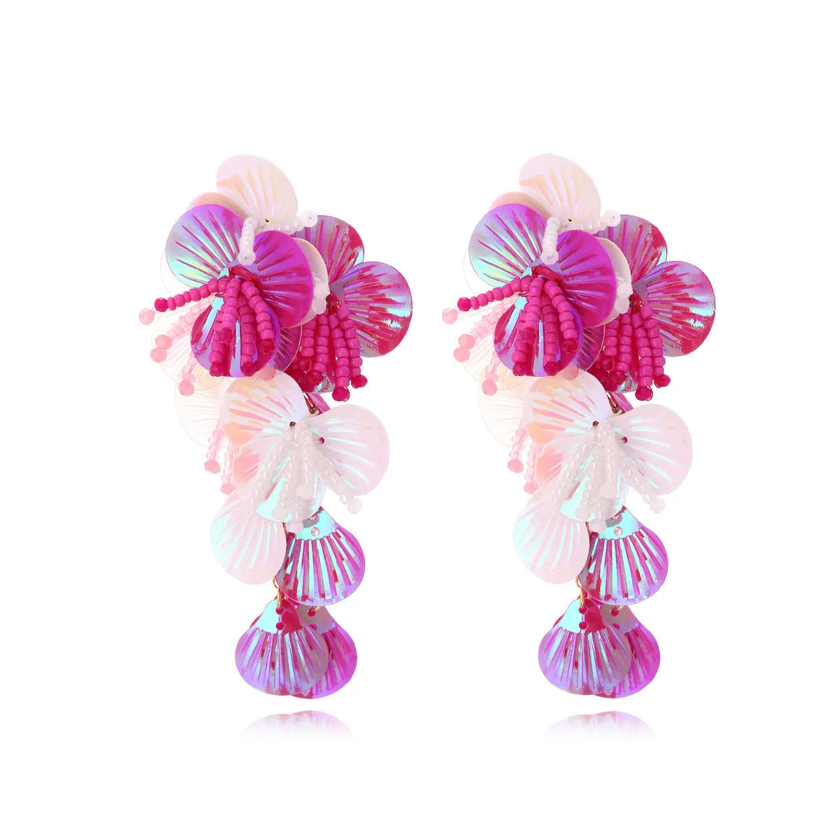 Close-up of handmade colourful bead flower and leaf statement earrings on a white background.