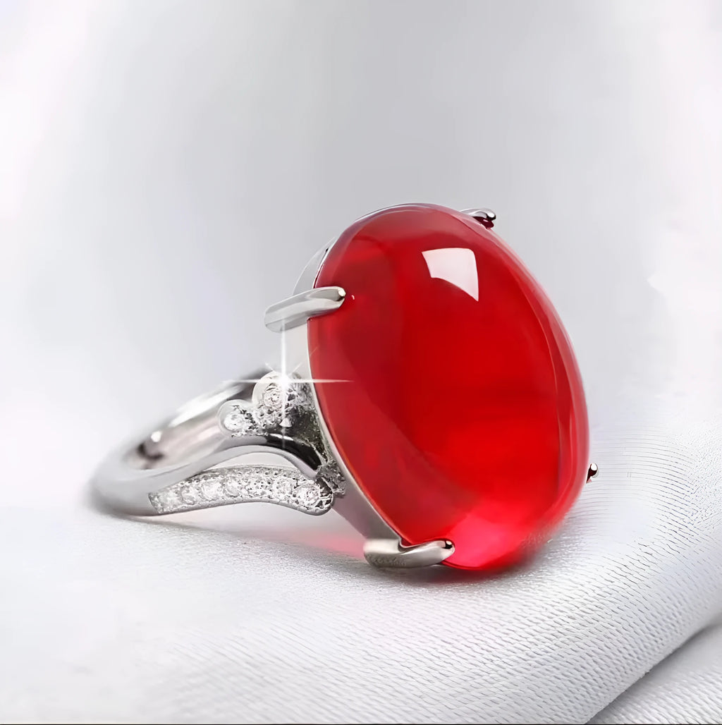 Geometric ethnic style adjustable alloy ring in one of five colours on a plain background.