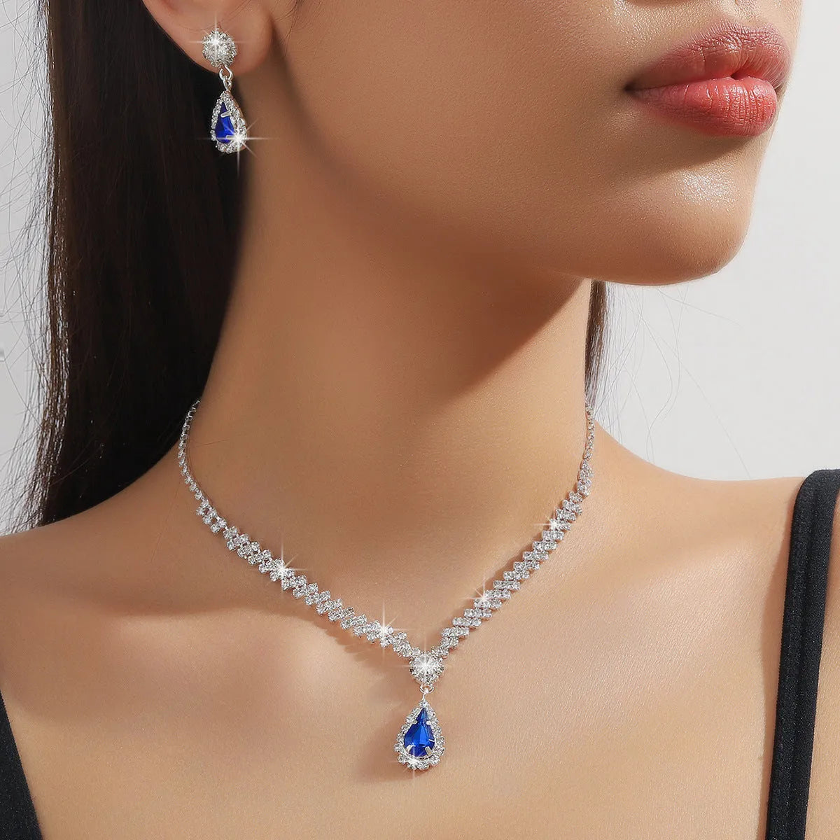 Women's claw chain necklace and earrings set with water drop rhinestones in multiple colour options