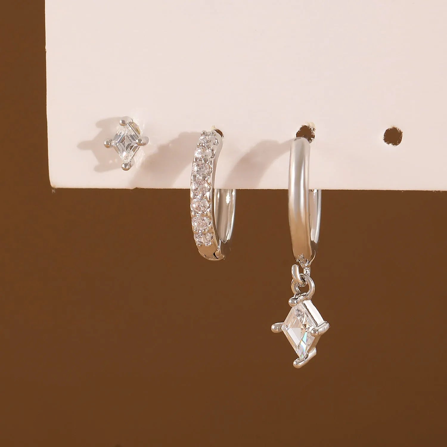 Ladies three-piece earring set with geometric zircon designs in gold and white colours