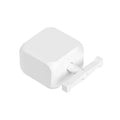 Small white Bluetooth rocker arm finger robot with remote control on a table.