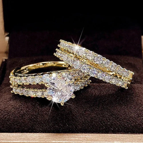 Two geometric women's rings with fully jewelled bands and round cut accents, shown in gold, rose gold, and silver colour options.