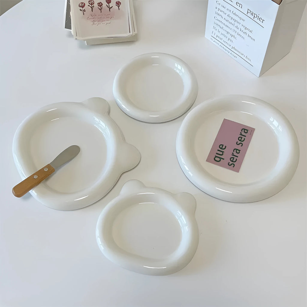 White porcelain plate with chubby toot or bear doodle pattern, shown in 15cm and 20cm round sizes.