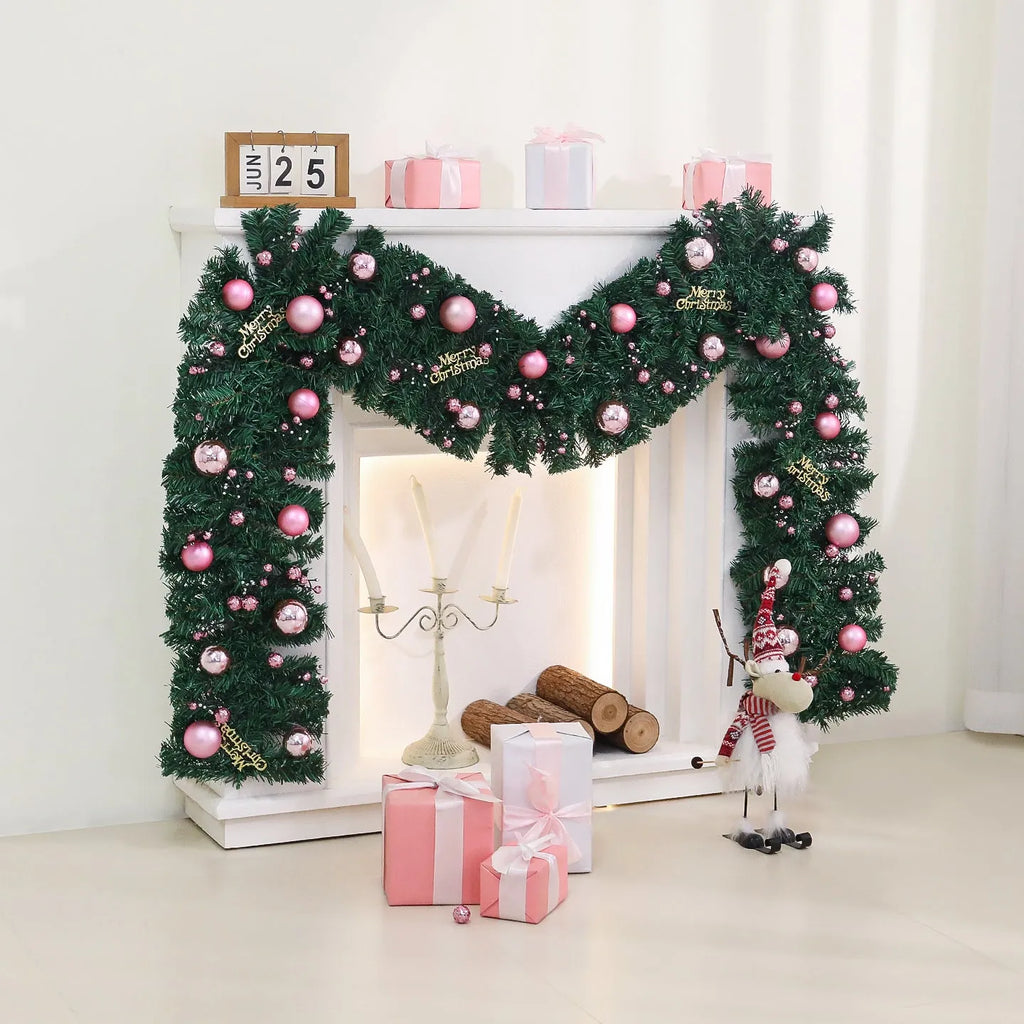 Pink artificial rattan Christmas garland with small fruit details and warm white LED lights, coiled to show its 2.7m length.