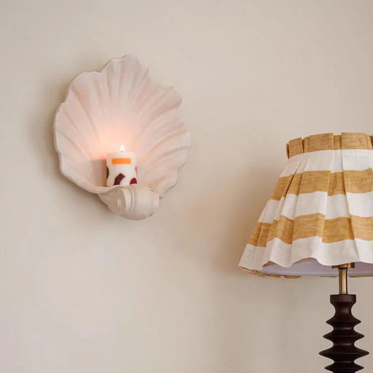 Close-up of a white resin decorative ornament with a detailed seashell design for fruit plates and table displays.