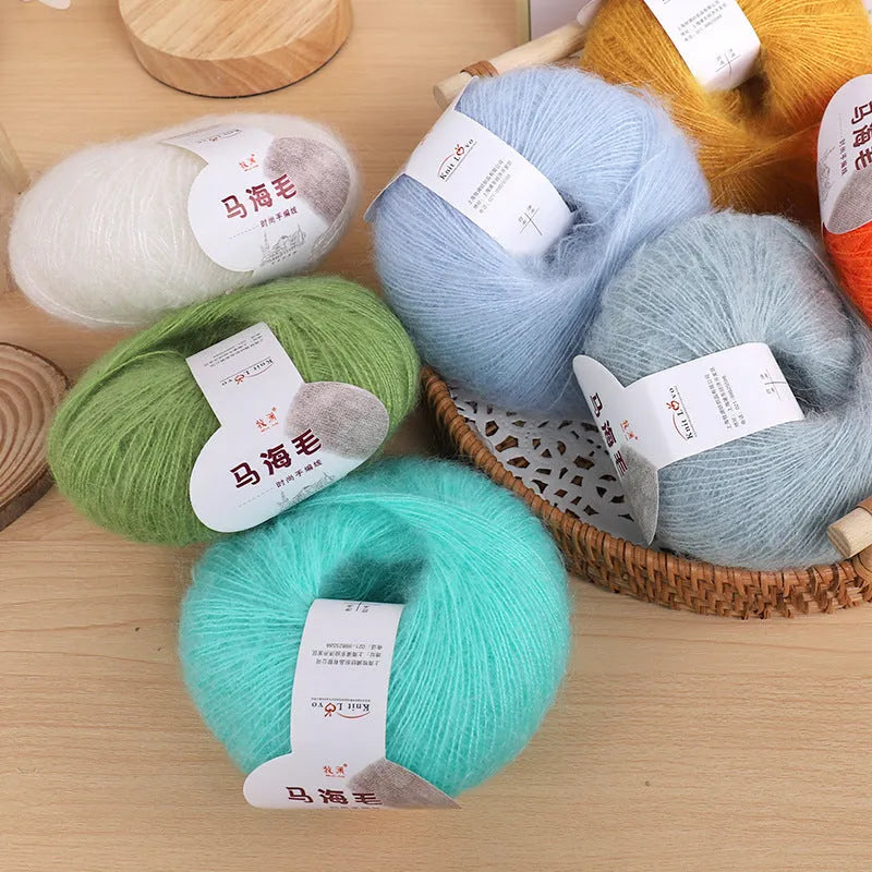 DIY mohair scarf weaving kit showing one wool ball and a selection of 34 colour options including white, pink, blue and green.