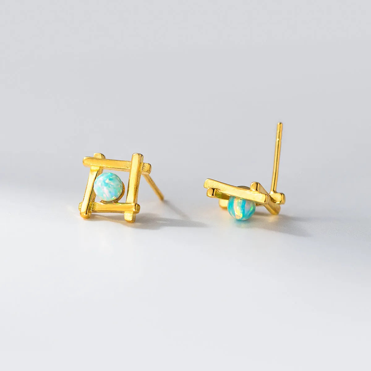 Women's geometric cross quadrangle stud earrings in sterling silver with gold or silver finish.