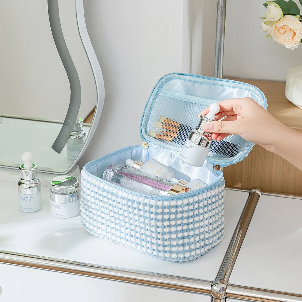 Four cube-style flannelette makeup bags in a set, shown in blue with dots colour option.