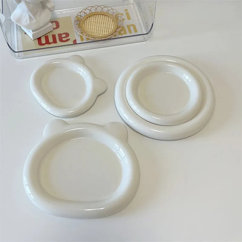 White porcelain plate with chubby toot or bear doodle pattern, shown in 15cm and 20cm round sizes.