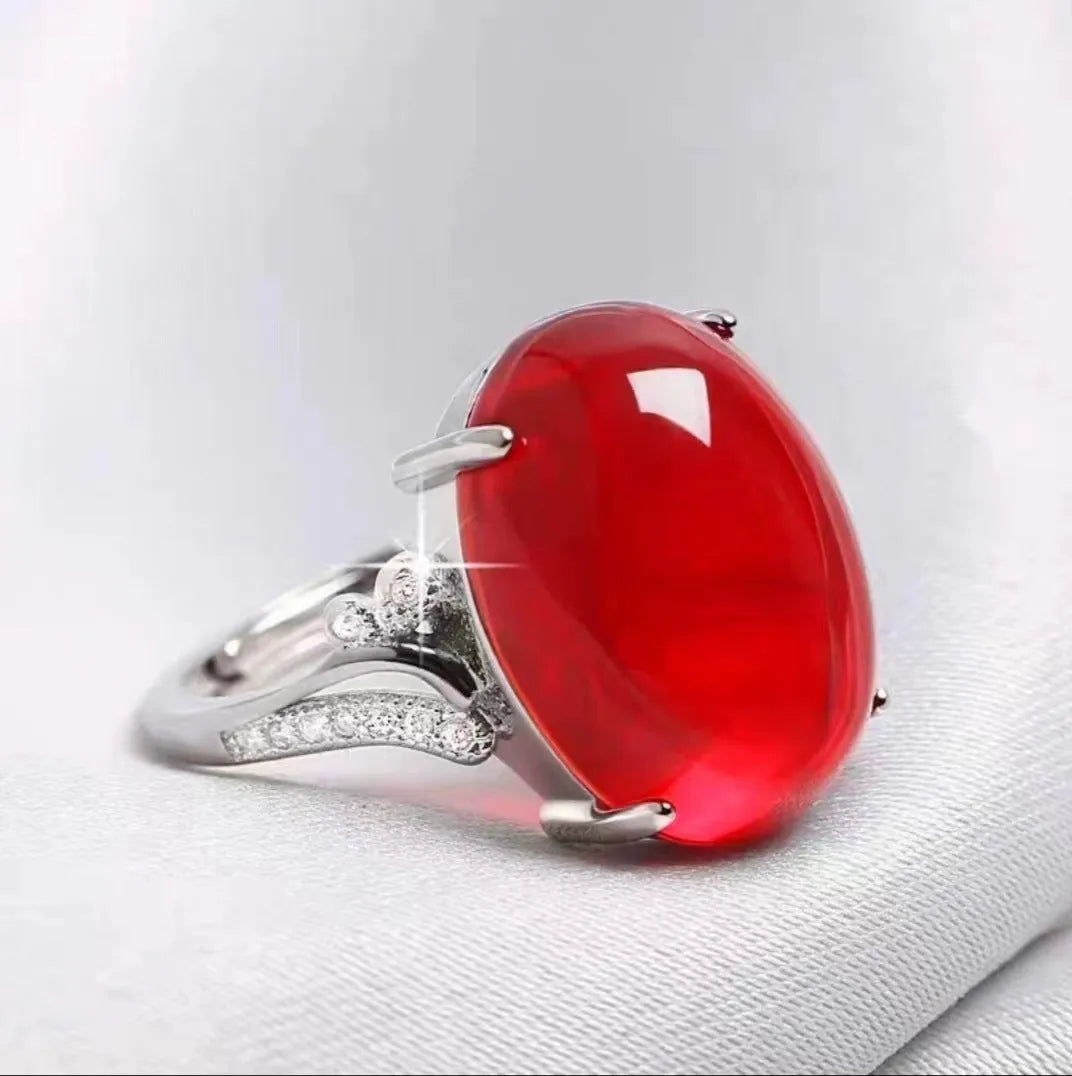 Geometric ethnic style adjustable alloy ring in one of five colours on a plain background.