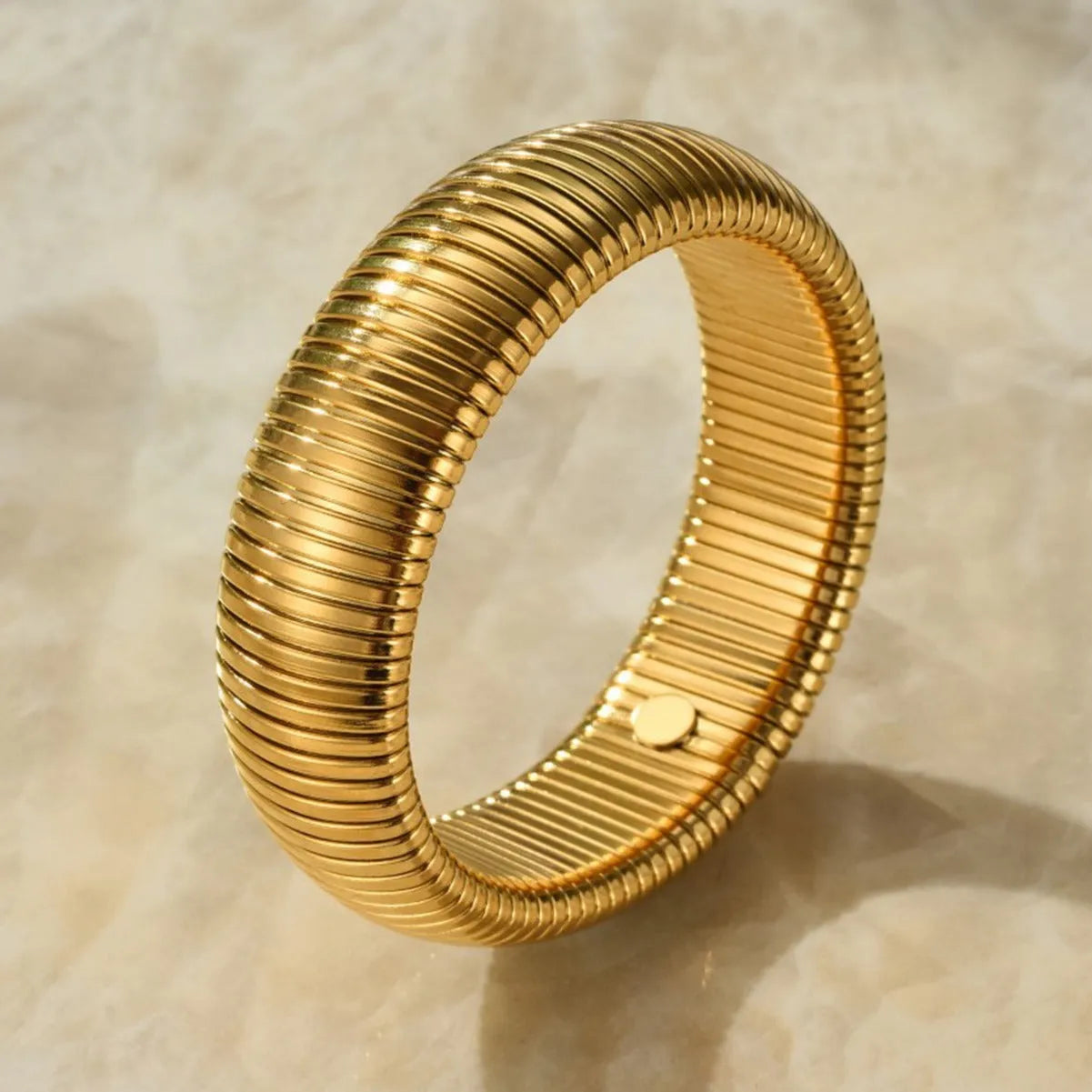 Women's titanium steel elastic bracelet with exaggerated vertical stripe pattern in gold finish