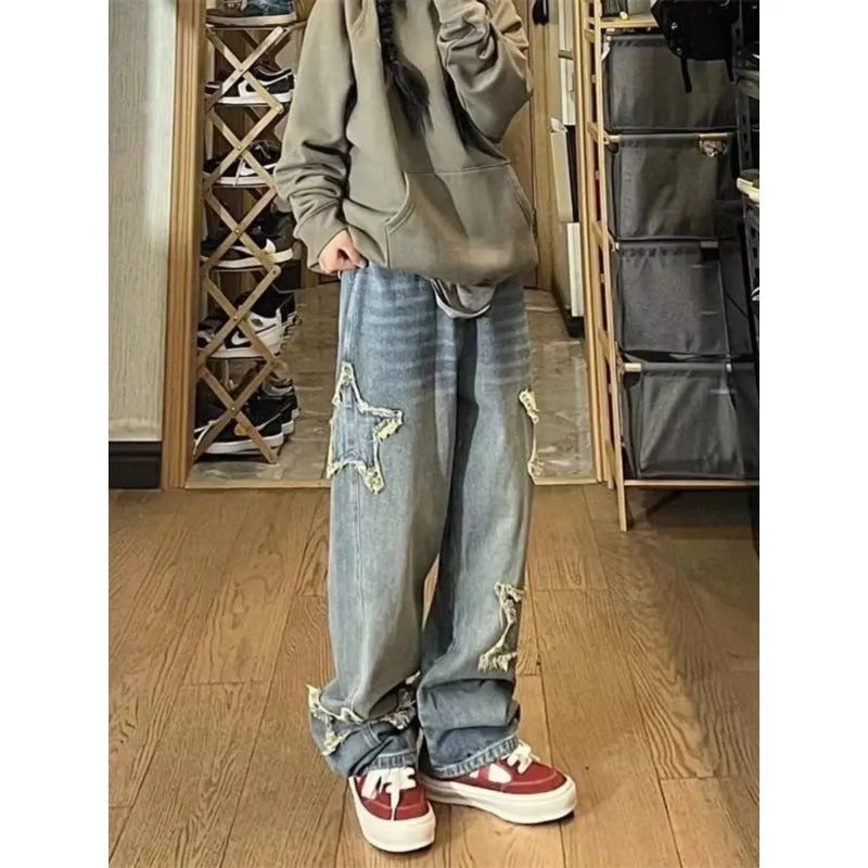 Blue high-waist straight-leg women's jeans on a hanger, showing the front detail and button fastening.