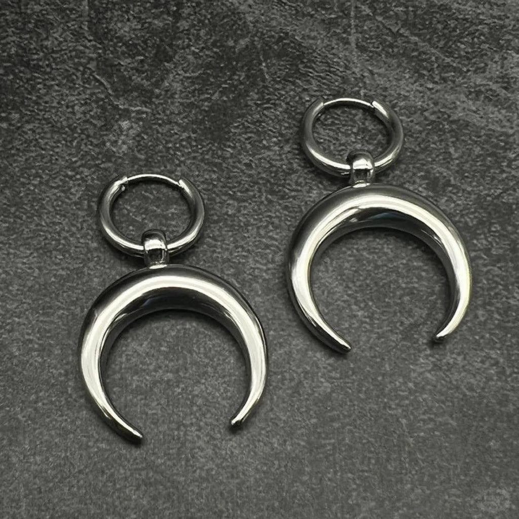Silver alloy big hoop earrings with a gothic moon design and ear clip back.