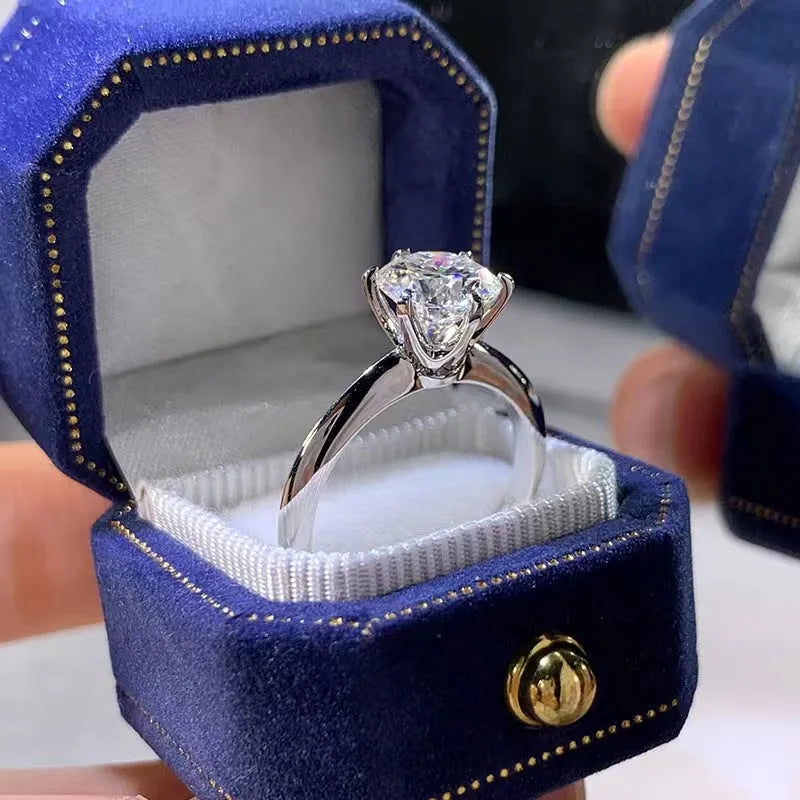 White gold plated geometric ring with a six-claw setting holding a central zircon stone.