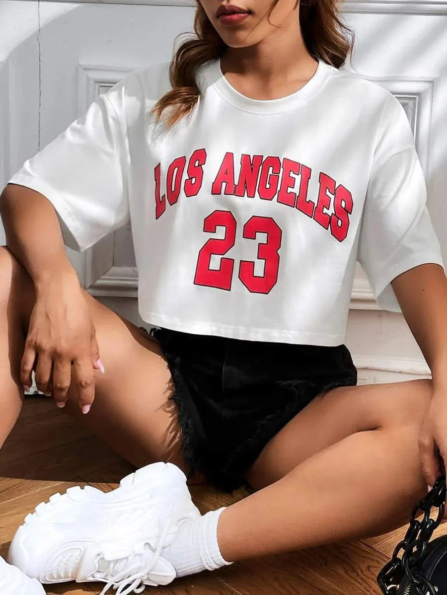 A loose-fit black cotton t-shirt with printed white English letters and an exposed navel design.