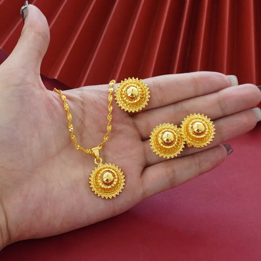 Three-piece gold-plated floral jewellery suit with necklace, earrings and ring on water wave chain