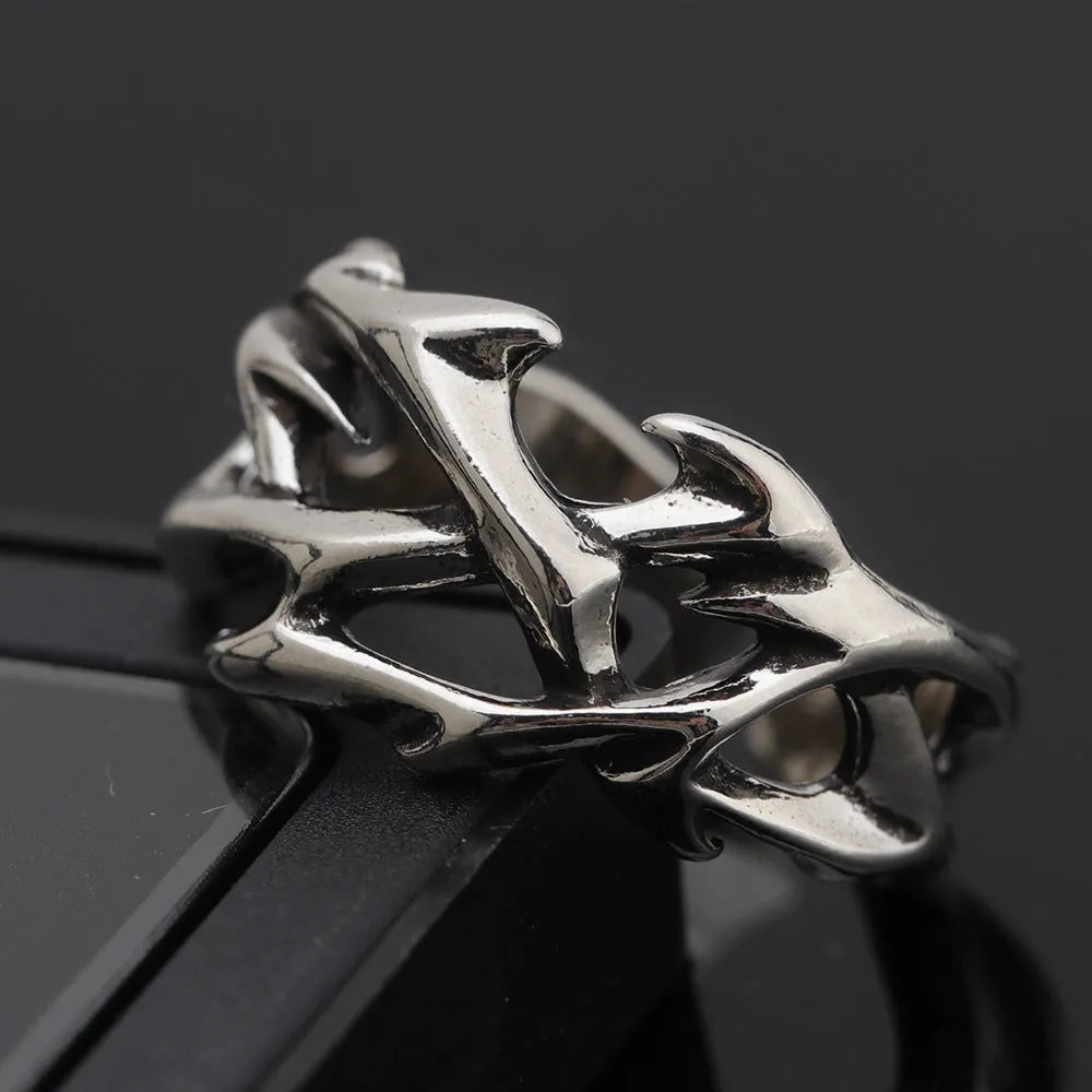 Copper geometric thorn flower ring with adjustable band on a finger, J2150 colour.