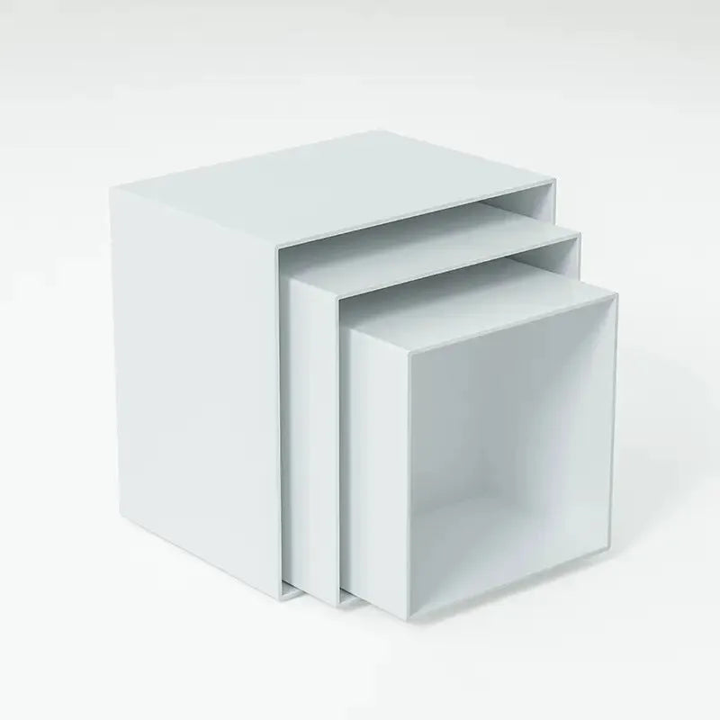 White plastic dessert table display stand with six cube-shaped racks for cakes and pastries.