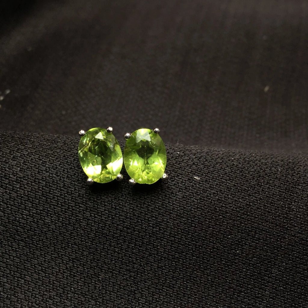 Natural olivine stud earrings with grass green oval stones in sterling silver setting