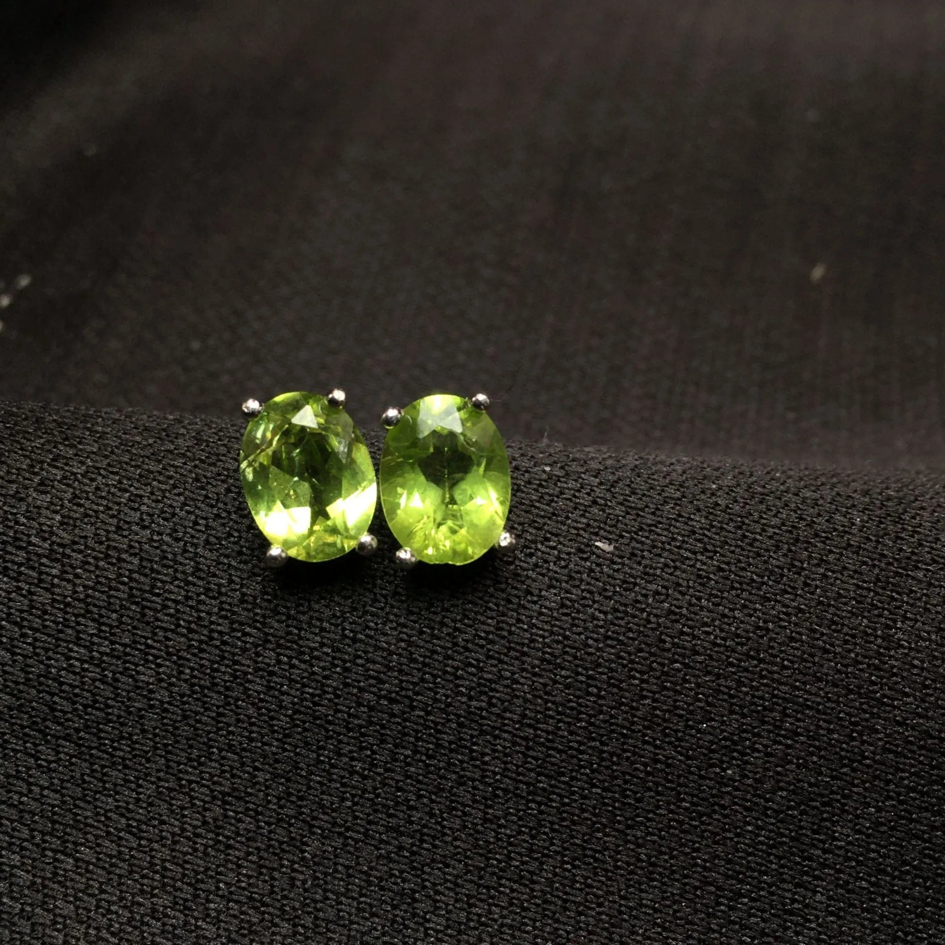 Natural olivine stud earrings with grass green oval stones in sterling silver setting