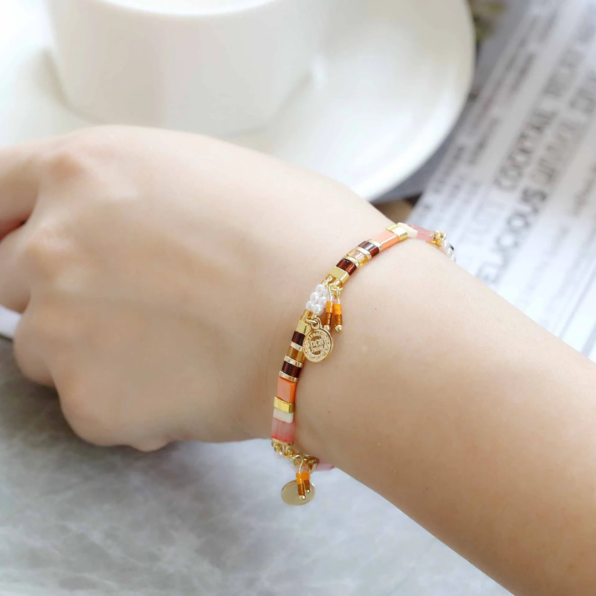 Handcrafted women's bracelet with imitation pearl beads in European style, showing colour variations.