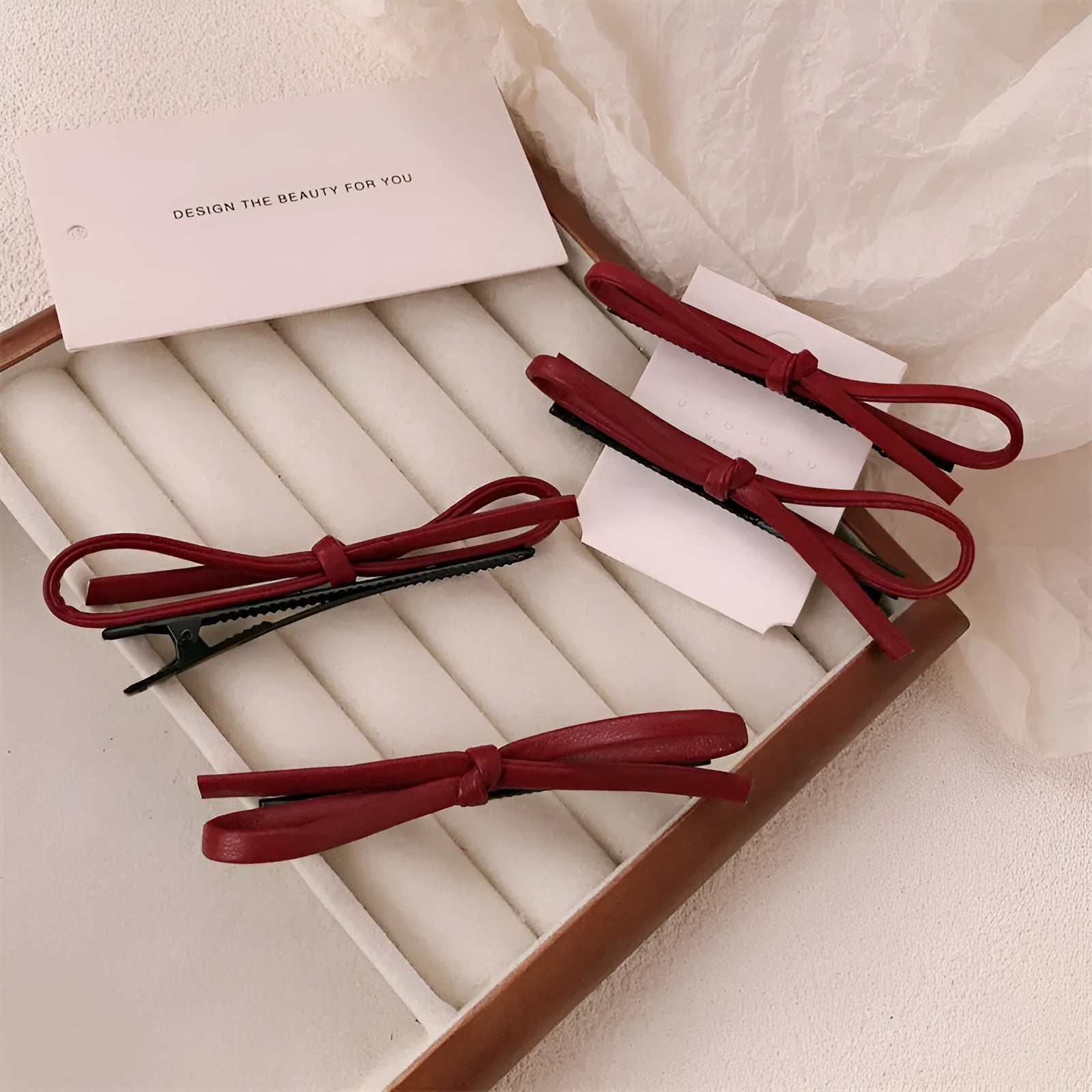 Wine red leather bow hair barrette showing bow design and clip mechanism