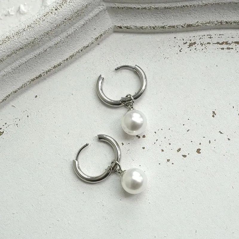 Women's geometric alloy earrings with a round pearl centre and titanium steel post.