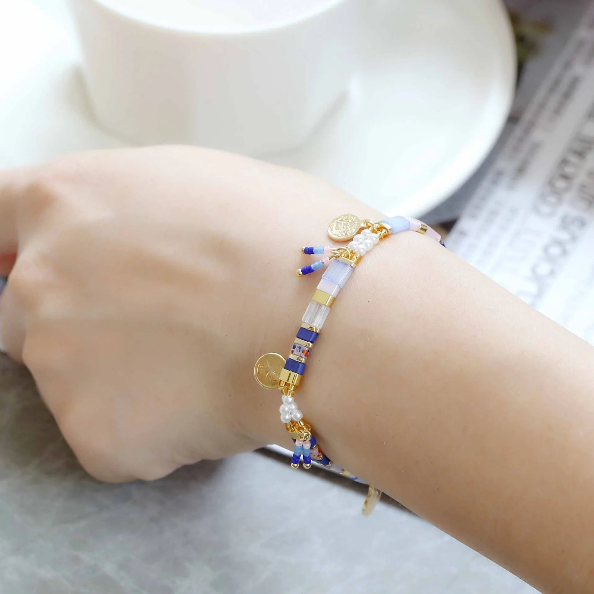 Handcrafted women's bracelet with imitation pearl beads in European style, showing colour variations.