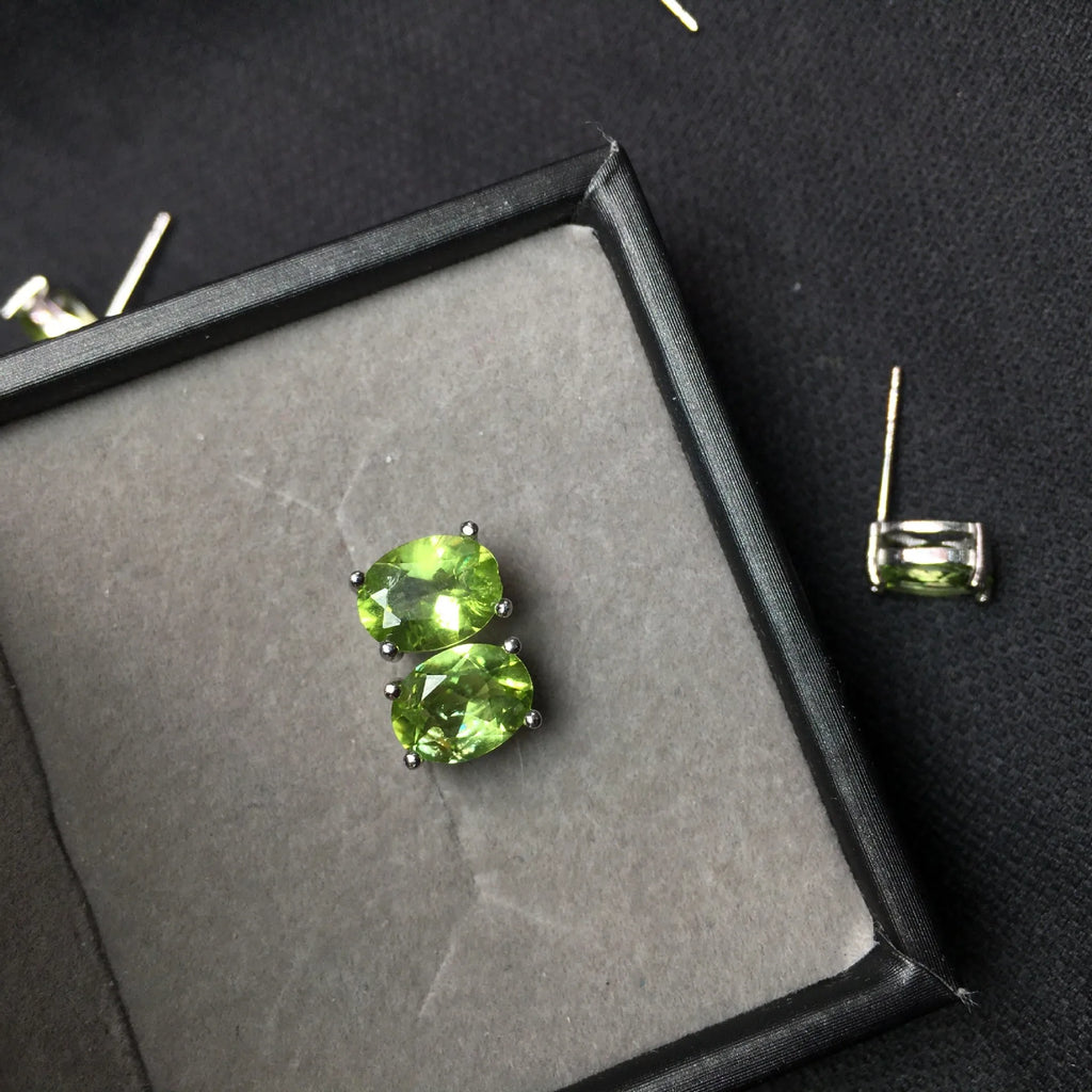 Natural olivine stud earrings with grass green oval stones in sterling silver setting