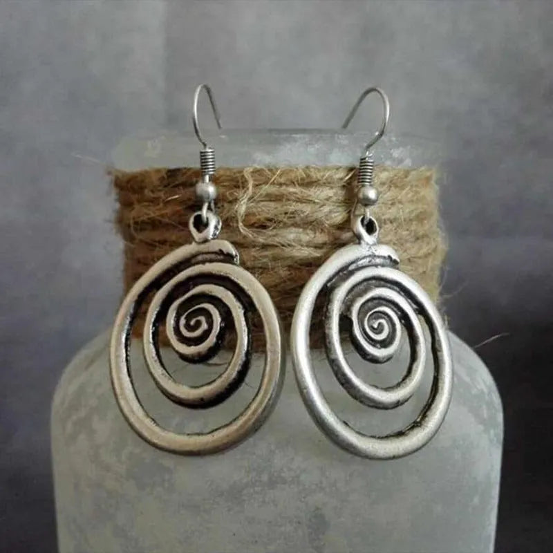 Silver geometric spiral earrings with distressed finish measuring 2.6cm by 5cm