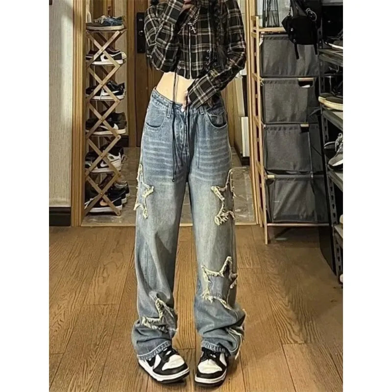 Blue high-waist straight-leg women's jeans on a hanger, showing the front detail and button fastening.