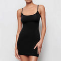 Black sleeveless sling dress with a short skirt and fitted sheath silhouette.