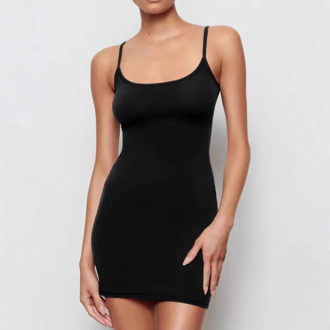 Black sleeveless sling dress with a short skirt and fitted sheath silhouette.