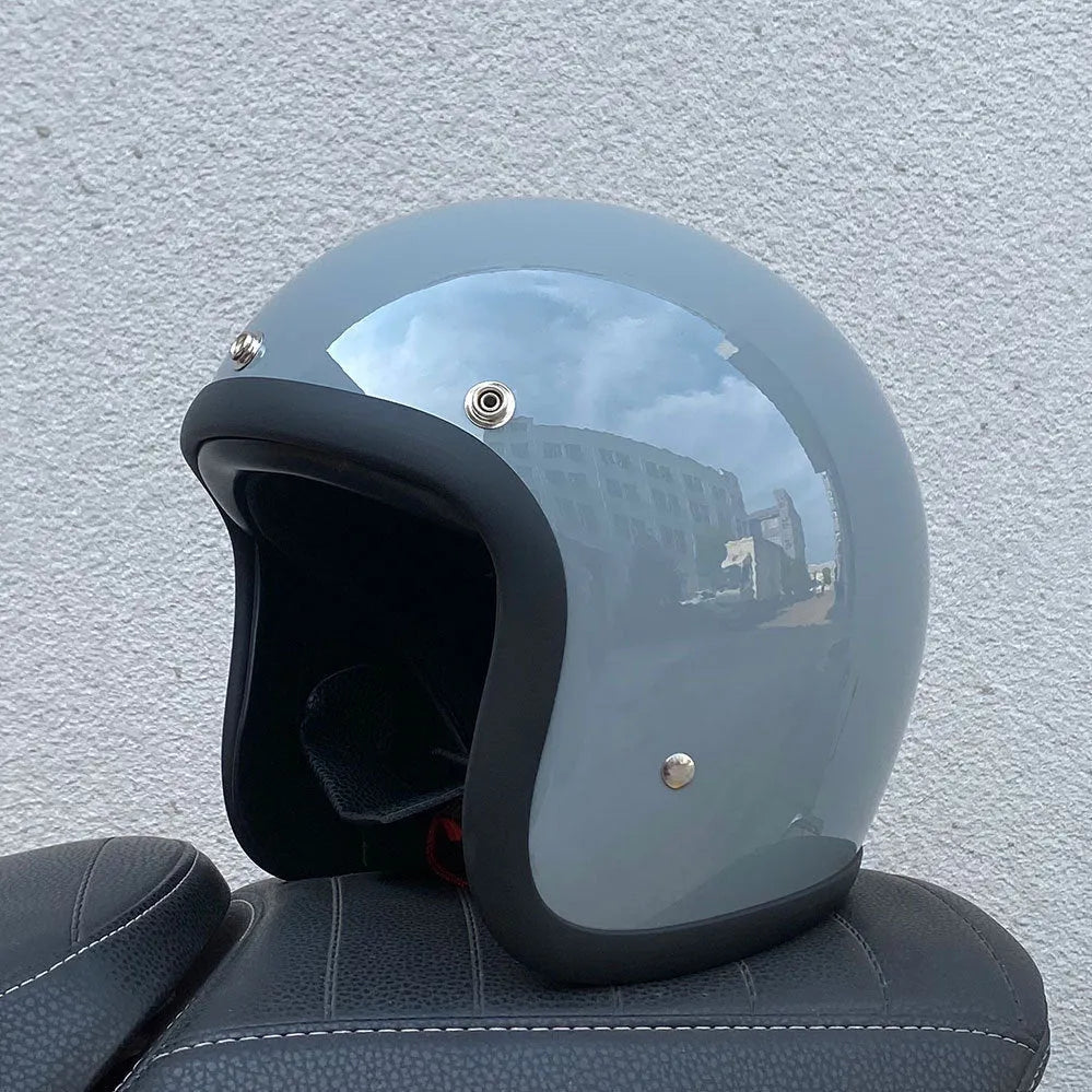 Glass fibre retro half motorcycle helmet shown in multiple colour options including cement grey and matte black flower patterns