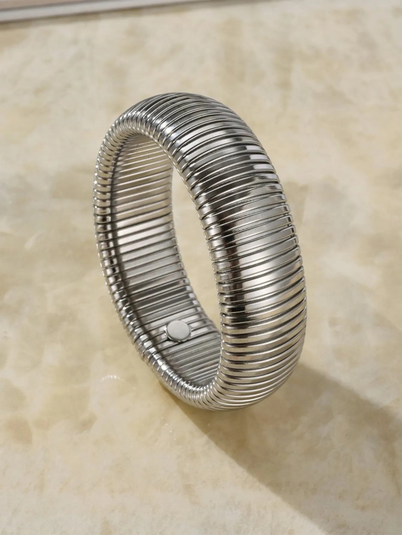 Women's titanium steel elastic bracelet with exaggerated vertical stripe pattern in gold finish