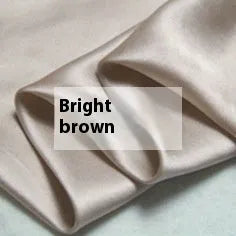 Solid colour double-sided silk duvet cover in bright brown, showing smooth texture and neat corner.