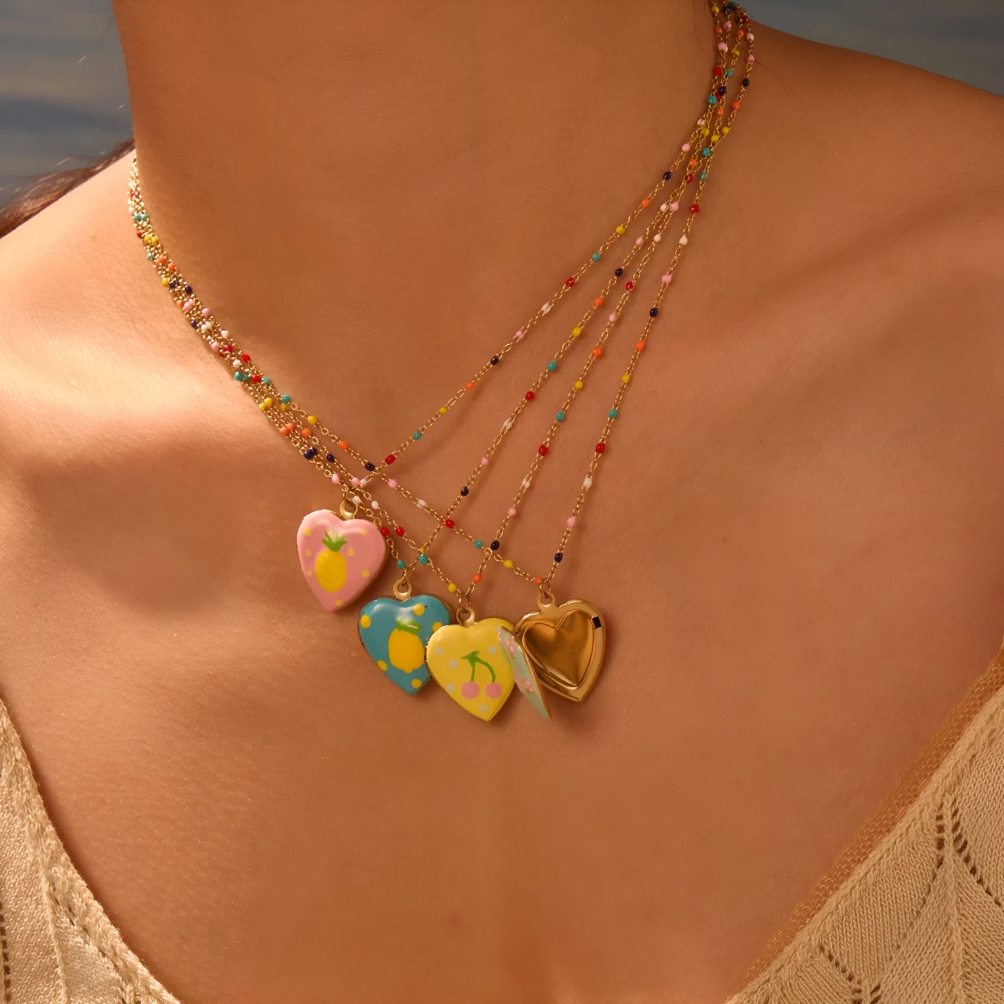 Women's stainless steel necklace with gold plating showing heart-shaped fruit pendant design on adjustable chain