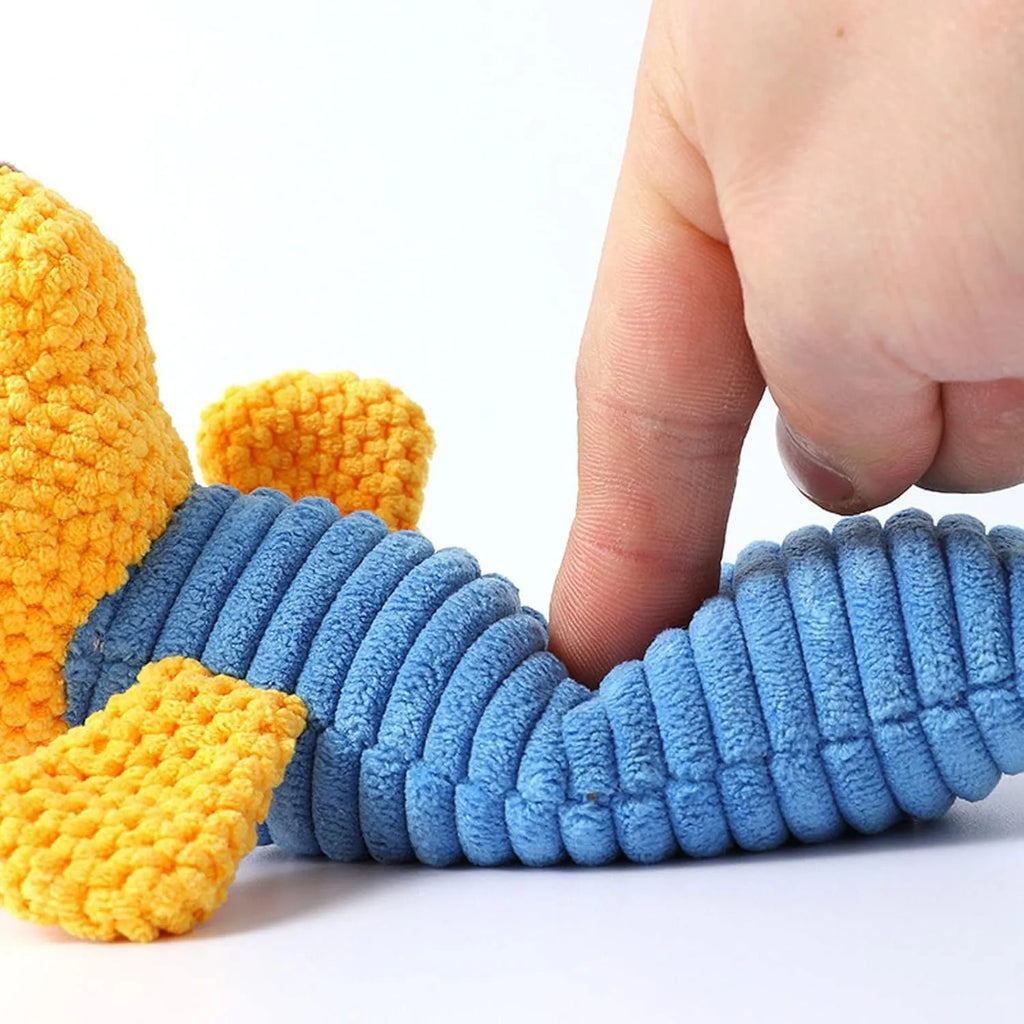 A cloth stuffed animal dog chew toy with a squeaker, shown next to a ruler measuring 19 cm in length.
