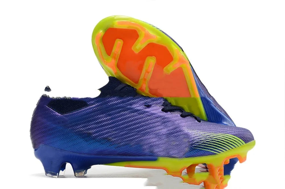 Men's black football shoes with FG studs, knitted upper, and lace-up closure on grass pitch