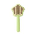 Green stainless steel self-cleaning cat comb with needle bristles on a white background.