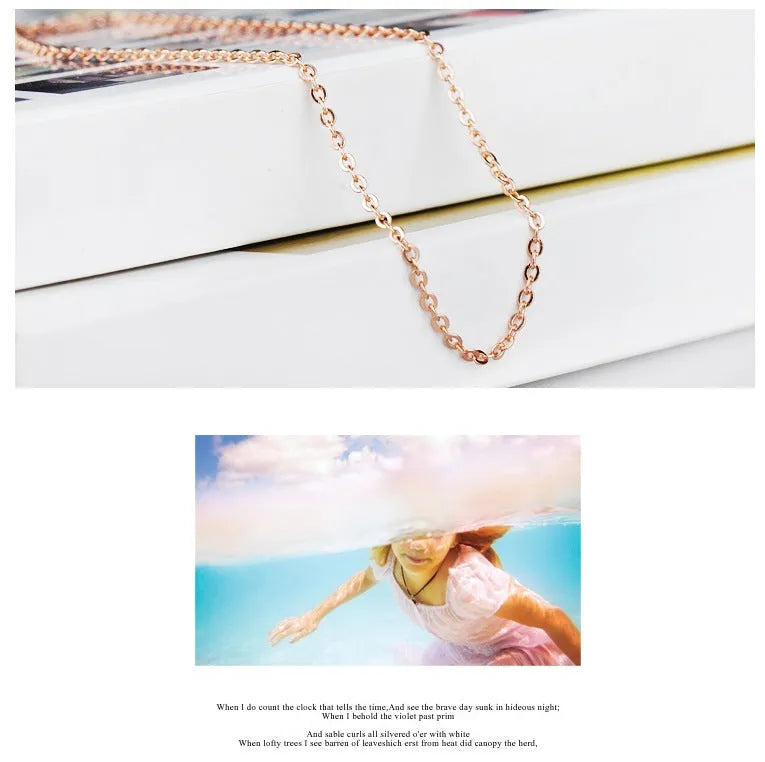 Rose gold heart-shaped pendant necklace with a pink synthetic crystal centre on a matching cross chain.