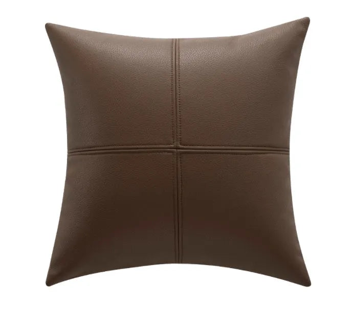 Soft cowhide leather pillow cover in a solid colour, shown in a Nordic-style room setting.